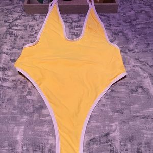 Yellow, trimmed in white thong one piece swimsuit